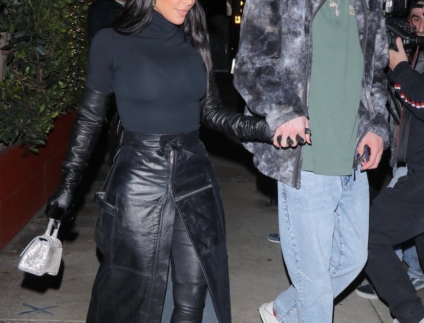 Kim Kardashian and Pete Davidson holding hands outside in a paparazzi photo