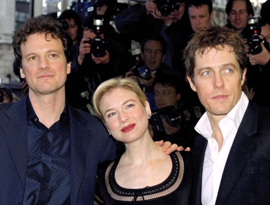 Colin Firth, Renée Zellweger, and Hugh Grant pose for a photo on a red carpet together