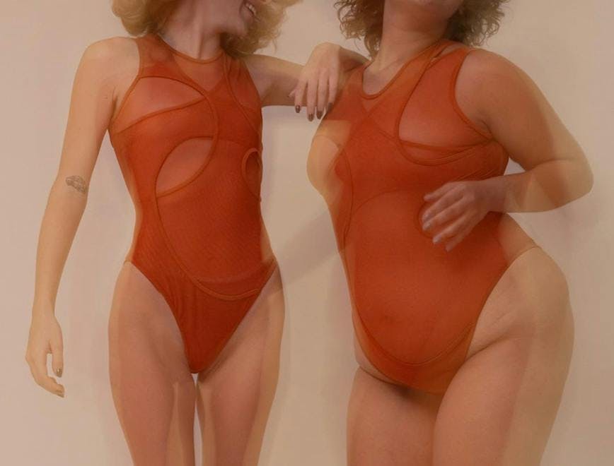 two models in a red subversive bodysuit